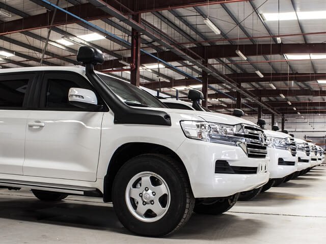 white Armored Land Cruisers in warehouse